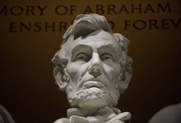A statue of President Abraham Lincoln dominates the interior of the Lincoln Memorial for tourists visiting at moonrise and sunset on the National Mall in Washington, DC on June 22, 2013. The biggest full moon of the year added to the National Mall attractions on a calm warm night in the nation s capital. The neoclassic monument is dedication to the 16th President of the United States.  WAS20130623133