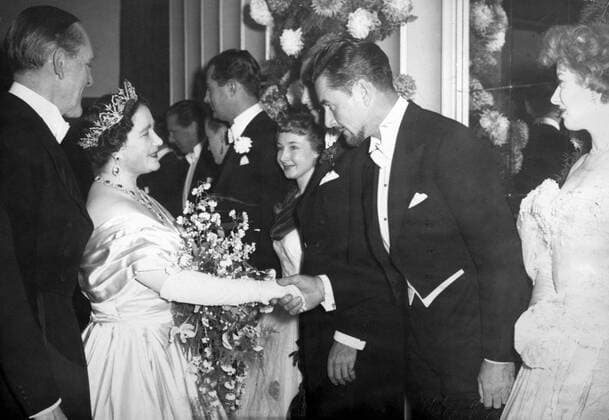 Presentation to the Queen at the royal Command Film Performance. Errol Flynn, the star of Forsyte Saga is presented to her Majesty by Jack Hulbert. On his right is the leading lady, Greer Garson. 18th November 1949 UnitedArchives00153242 