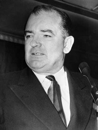 Senator Joseph McCarthy of Wisconsin looks grim as he talks to newsmen on his return to Washington . In at alk before leaving his home state , the Senator said he had a secret witness who can substantiate his charge that the Army Secretary Robert Stevens , attempted to head off his probe of the army by offering dirt on the navy and air force . 17th March 1954 UnitedArchives00153416 