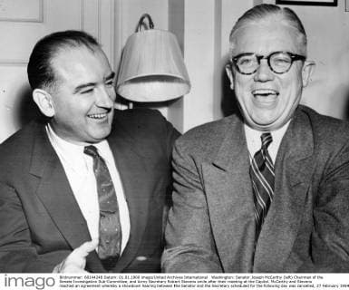 Washington: Senator Joseph McCarthy (left) Chairman of the Senate Investigation Sub-Committee, and Army Secretary Robert Stevens smile after their meeting at the Capitol. McCarthy and Stevens reached an agreement whereby a showdown hearing between the Senator and the Secretary scheduled for the following day was cancelled, 27 February 1954  UnitedArchives00938492