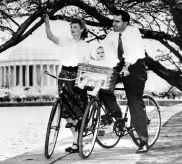 With 13 month old daughter Patricia riding in a specially fitted bicycle basket, Richard Nixon of California and Mrs Nixon pause here on 13th April 1947 to admire the cherry blossoms 28th July 1960  UnitedArchives01006846
