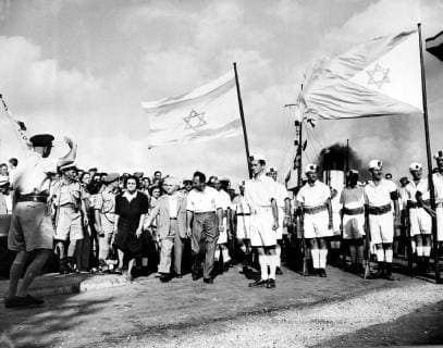 Israel s Prime Minister, David Ben Gurion (centre left, with jacket) with his wife to see the last of the British soldiers leave Haifa Docks. he is seenpassing a small detachment of the Jewish Navy. 3 July 1948  UnitedArchives01011316