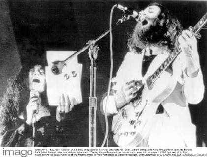 John Lennon and his wife Yoko Ono performing at the Toronto Rock & Roll Revival in an unscheduled appearance. During the performance the couple were booed off the stage. 20,000 fans waited for four hours before the couple went on at the Varsity Arena, in their first stage appearance together. 14th September 1969 577928  UnitedArchives01027859