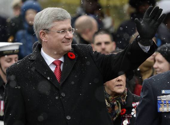 OTTAWA, Nov. 11, 2013 - Canada s Prime Minister Stephen Harper waves to the crowd during the closing parade of the Remembrance Day ceremony at the National War Memorial in Ottawa, Canada, on Nov. 11, 2013. Remembrance Day is a memorial day observed in Commonwealth countries to remember the sacrifices of the armed forces and civilians in times of war, specifically since the First World War. (Xinhua James Park) (lyx) CANADA-OTTAWA-REMEMBRANCE DAY 