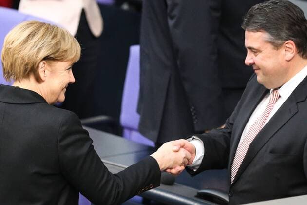(131217) -- BERLIN, Dec. 17, 2013 (Xinhua) -- German Chancellor Angela Merkel (L) shakes hands with German Vice-Chancellor and Minister of Economics and Energy Sigmar Gabriel during the meeting of Bundestag, Germany s lower house of parliament, in Berlin, Germany on Dec. 17, 2013. German new government headed by Chancellor Angela Merkel was sworn into office on Tuesday to rule Europe s biggest economy for the next four years. Cabinet ministers of the new coalition government, are formed by Merkel s Christian Democratic Union (CDU), its Bavarian sister party Chrisitian Social Union (CSU), and the Social Democrats (SPD). (Xinhua Zhang Fan)(srb) GERMANY-BERLIN-NEW GOVERNMENT 