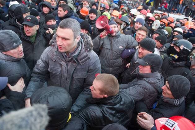 ITAR-TASS: KIEV, UKRAINE. JANUARY 19, 2014. Udar party leader Vitali Klitschko (C) sprayed with powder from a fire extinguisher near Dynamo Stadium during clashes between opposition and police. Protesters rally against new laws passed by Ukrainian parliament.  RE136554