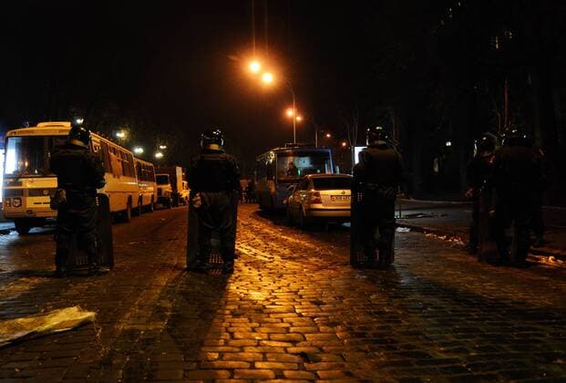 (140219) -- KIEV, Feb. 19, 2014 (Xinhua) -- Policemen check vehicle at a crossing near the Independence Square, the main site where protesters had camped, in Kiev, Ukraine, Feb. 19, 2014. On Tuesday and in the early hours of Wednesday, at least 26 people died in street clashes between the riot police and protesters in Kiev. (Xinhua Liu Hongxia) UKRAINE-KIEV-INDEPENDENCE SQUARE 