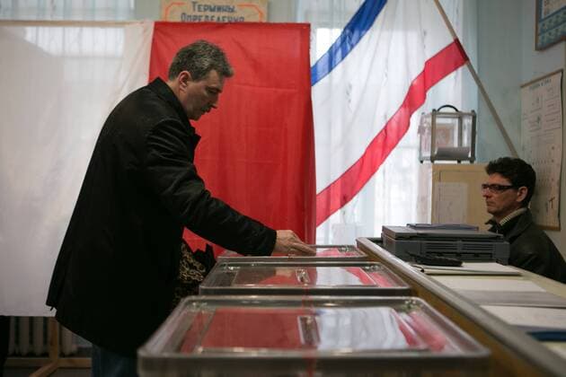 Referendum starts in Crimea. A man gives her vote in Simferopol, . Sunday, 16th March 2014. Picture by Daniel Leal-Olivas i-Images DanielxLeal-Olivas  IIM-1784-0017