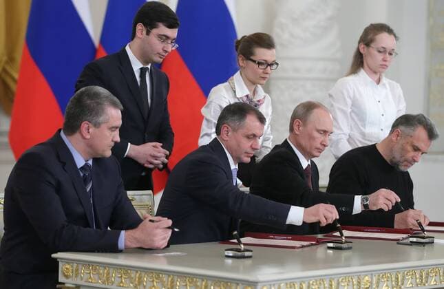 ITAR-TASS: MOSCOW, RUSSIA. MARCH 18, 2014. Crimean Prime Minister Sergei Aksenov, Crimean Supreme Council chairman Vladimir Konstantinov, Russian president Vladimir Putin, and Sevastopol head Alexei Chalyi (L-R front) sign an interstate unification agreement between the Russian Federation, the Republic of Crimea and the city of Sevastopol. Under the terms of the agreement, the Republic of Crimea and Sevastopol become federal subjects of the Russian Federation.  RE13D26E