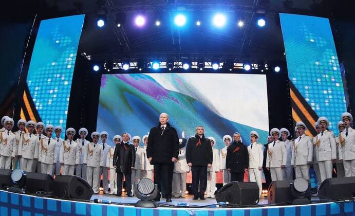 ITAR-TASS: MOSCOW, RUSSIA. MARCH 18, 2014. Russian president Vladimir Putin (C front), Crimean Supreme Council chairman Vladimir Konstantinov, Crimean Prime Minister Sergei Aksenov, and Sevastopol head Alexei Chalyi (L-R centre back) at a concert in Red Square celebrating an interstate unification agreement between the Russian Federation, the Republic of Crimea and the city of Sevastopol. Under the terms of the agreement, the Republic of Crimea and Sevastopol become federal subjects of the Russian Federation.  Highlight RE13D311