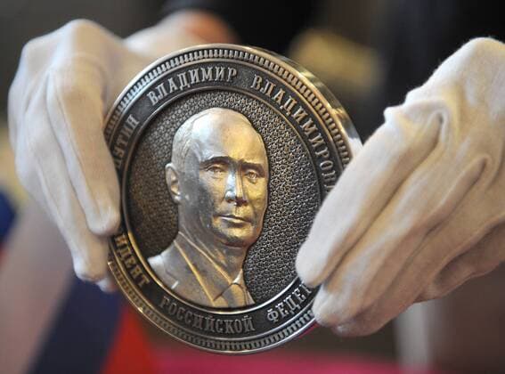 ITAR-TASS: CHELYABINSK REGION, RUSSIA. APRIL 23, 2014. Unveiling a commemorative silver coin marking Crimea s incorporation into Russia. The coin bears an image of Russia s president Vladimir Putin on the obverse. A map of the Crimean Peninsula is depicted on the reverse.  Aufmacher RE1410AE