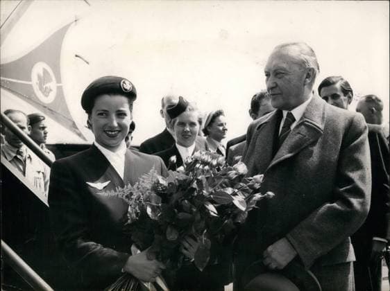 May 05, 1953 - Adenauer leaves Germany for Paris. Attends European Coal and Steel Board Conference.: Dr. Konrad Adenauer, the chancellor of the West German Federal Republic, is supposed to leave Germany to attend the European Coal Steel Conference. Before he boarded the plabe, 22-year-old Margot Wirges, a girl from Cologne, Adenauer s native-city, and Air France stewardess, presented the chancellor a big bouquet of Gloria-Dei-Roses, the chancellor s favorite flowers. Photo shows Dr. Konrad Adenauer, and Air France Stewardess Margot Wirges, at the Cologne- Wahn Air Base, on 11 May 53.  - ZUMAk09