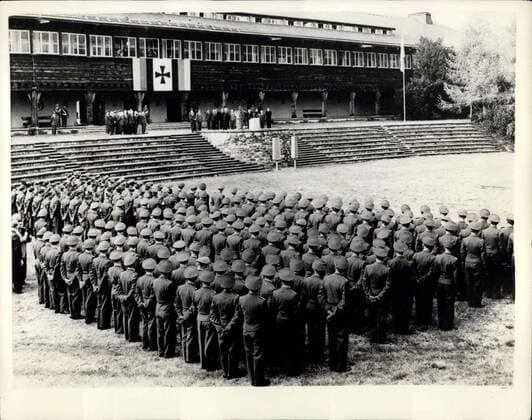 May 18, 1956 - German Forces In Training At Former Castle.: Higher officers of the new German Army are undergoing their training at Ludwig Beck Barracks - the former Castle of Sonthofen. Photo shows General flew as officers in training parade at the Castle - when Bavarian President Hogner and other leading figures paid them a visit.  - ZUMAk09