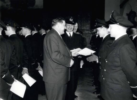 Apr. 02, 1957 - 115 ensigns and cadets received their recognition certificates on April 4 in the Flensburg-M?rwik naval academy from Defense Minister Franz Joseph Strauss. Pictured: Defense Minister Franz Joseph Strauss (in civvies) handing over the recognition certificates.  - ZUMAk09