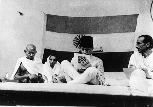 July 15, 1946 - Delhi, India - MAHATMA GANDHI goes on spinning at The all India Commitee debates while MOULANA AZAD (outgoing President) is reading and ACHARYA KIRPALINI is looking on. Delhi India  - ZUMAk09
