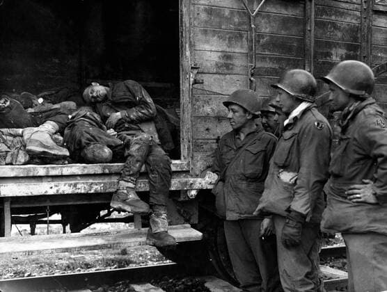 IMAGO History, Zweiter Weltkrieg: 1939 - 1945 Oct. 5, 1945 - Dachau, Bavaria, Germany - Dachau, the most infamous Nazi concentration camp of all has been liberated by men of the 42nd Rainbow Division of the U.S. 7th Army. Scenes of appalling horror were witnessed by the American troops as they went from building to building. Thousands of starved corpses were piled nearly to the roof awaiting cremation. Many of the prisoners immediately seized the S.S. torturers and killed them, throwing their bodies into the moat surrounding the camp. Picture shows: No room to lie down. This Polish prisoner died sitting upright in a goods wagon. Dachau Germany  - ZUMAk09