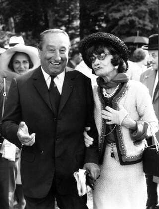 IMAGO ICONS: Coco Chanel Jan. 1, 1968 - Paris, France - COCO CHANEL (born Gabrielle Bonheur Chanel) was a pioneering French fashion designer whose modernist philosophy, menswear-inspired fashions, and pursuit of expensive simplicity made her arguably the most important figure in the history of 20th-century fashion. PICTURED: Chanel walking with a man. Paris France  - ZUMAk09