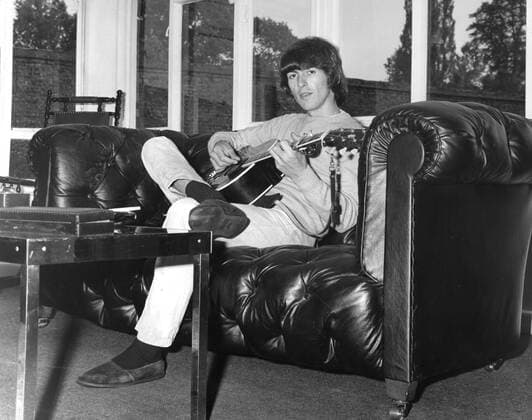 Aug. 9, 1969 - Weybridge, Surrey, U.K. - The Beatles bass player GEORGE HARRISON relaxes with his guitar in his elegant home. Weybridge United Kingdom  - ZUMAk09