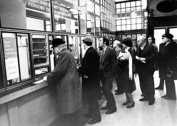 Nov 29, 1973 - London, England, UK - The 1973 oil crisis began on October 17, 1973, when the members of Organization of Arab Petroleum Exporting Countries announced, as a result of the ongoing Yom Kippur War, that they would no longer ship oil to nations that had supported Israel in its conflict with Syria and Egypt (the United States, its allies in Western Europe, and Japan). Because of the dependence of the industrialized world on crude oil and the predominant role of OPEC as a global supplier, these price increases were dramatically inflationary to the economies of the targeted countries, while at the same time suppressive of economic activity. The targeted countries responded with a wide variety of new, and mostly permanent, initiatives to contain their further dependency. PICTURED: People standing in a line to acquire oil ration cards. London UK  - ZUMAk09