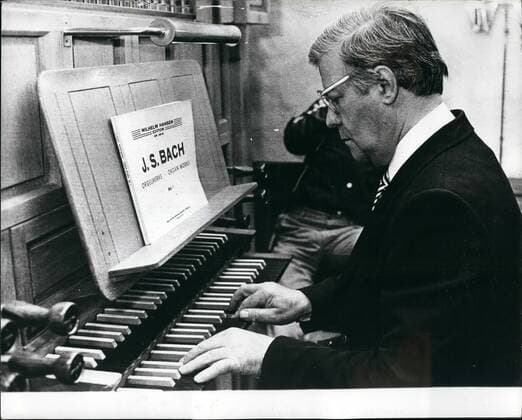 Helmut is Bach: Evidently Helmet Schmidt, prefers Bach to Strauss, Schmidt recently received the confidence of his compatriots to continue as Prime Minister of Germany. Photo shows Here he is playing the organ in a Danish church during recent visit to Denmark.  - ZUMAk09