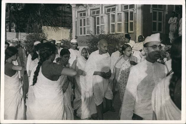 Jun. 06, 1935 - Mahatma Gandhi and evening prayer: Mahatma Gandhi is seen going into his evening prayer and the lady volunteers pay their respects to him by raising their hands upto their breasts.  - ZUMAk09