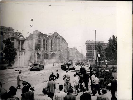 Jun. 17, 1953 - Demonstrations and riots in East - Berlin - Soviet Occupation Troops go into action against Civilian population: Heavy demonstrations and street -fights occurred in Berlin when laborers residing in East Berlin revolted against the East German Blood - Regime. Trusting that the Soviet high Commissioner, Semjono~, would immediately remove the Ulbricht - Grotsewohl government, the laborers rose-up and demanded liberty, freedom of speech and De-activation of the People s Police . To the surprise of many demonstrators, the Russian town commander ordered a tank - brigade into the threatened area, (Illegible) . Russian T-34 tanks seen blocking one of the may streets right in the very center of the East Berlin sector. Civilians stop and wait until the monsters have passed by, in order to cross the street, to escape into another area.  - ZUMAk09