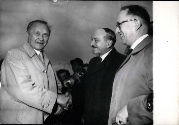 Oct. 10, 1954 - Franco -German Talks opens in Paris: Chancellor Konrad Adenauer Welcomed by M. Berthoin, French Minister of National Education, on his Arrival at orly airfield this morning . on Right Prof. Hallstein , Adenauer Assistant.  - ZUMAk09