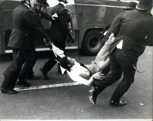 Apr. 04, 1981 - Rioting Hits Brixton For The Second Night: Rioting looting and arson spread through the the streets of Brixton, in South London last night, for the second successive night running-with police using their riot shields to charge the marauding gauge of youths-most, but not all of them, blank, Police buses and vans were attacked and shape, pubs and cars act alight. By late last night 201 policeman and two police women had been injured and 213 people arrested since the weekend trouble flared up on Saturday evening. Photo shows Police making an arrest when violence broke out once again in Brixton last night.  - ZUMAk09