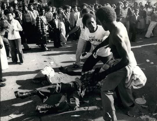 Aug. 08, 1977 - Violence Flares At The Notting Hill Carnival: Mobs of rioting youths clashed with police during the Notting Hill Carnival last night as police moved in they were met with a hail of beer can and bottles, bricks chair legs. By midnight the number of injured had reached 220, of which 90 were taken to hospital some with stab wounds. Photo Shows: Black youths fighting in the streets of Notting Hill yesterday during the carnival yesterday.  - ZUMAk09