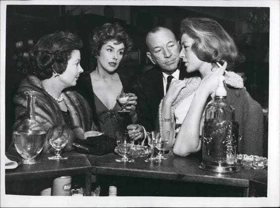 Jan. 01, 1959 - The lucky Squire of London town Noel Coward escorts three fascinating women: Mr. Noel Coward was surely the luckiest man in London last night, when, bearing like a benevolent sultan he escorted three of the world s most fascinatiing women, Kay Kendall, Vivian Leigh and Lauren Bacall, to the St Martin;s Theatre. They went to see The grass is greener starring their mutual friend, Celia Johnson. The party had been laid on by Vivian Leigh. Photo shows during the Interval Noel takes the trio for a drink and here he is chatting at the bar to (L to R) Vivian Leigh, Kay Kendall and Lauren Bacali.  - ZUMAk09