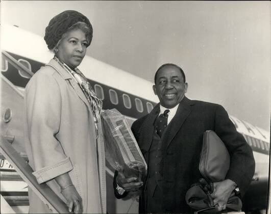 Feb. 02, 1964 - Sir Learie Constantine Goes Home.: Sir Learie Constantine, former West Indian Test cricketer, and High Commissioner for Trinidad in London, left London Airport with his wife this morning, on his way back to the West Indies. Photo shows Sir Learie and Lady Constantine at the Airport this morning.  - ZUMAk09