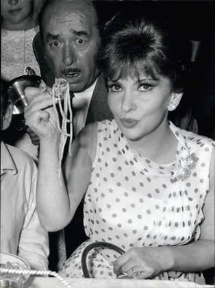 Jul. 07, 1965 - Rome: Italian screen star Gina Lollobrigida was the first guest to the The Longest feast of the world , organized in Ariccia, 30km from Rome. Photo Shows Gina Lollobrigida is eating the Spaghetti  - ZUMAk09