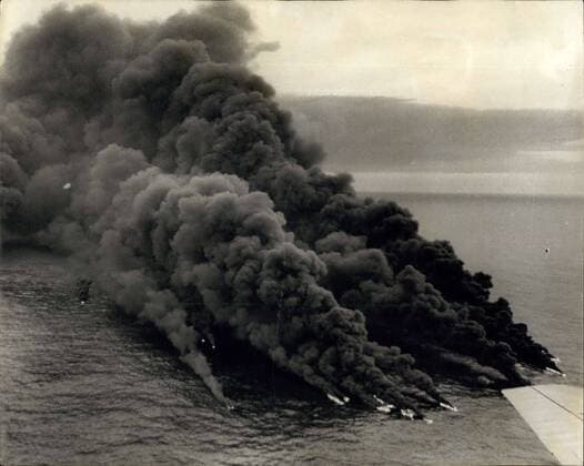 Mar. 29, 1967 - Torrey Canyon Blaze Is Put Out By The Tide: Last night s high tide put out the blaze on the wracked tanker Torrey Canyon started yesterday by Naval and R.A.F. planes with bombs and tanks of jet fuel. Naval Buccaneers fropped 36 1,000lb. bombs on the tanker - of which about 30 were on target. Then Hunter jets jettisoned their wing-tip drop tanks - each with 100 gallons of petrol to keep the blaze alive. Photo shows The huge smoke column from the stricken Torrey Canyon, off land s End yesterday.  - ZUMAk09