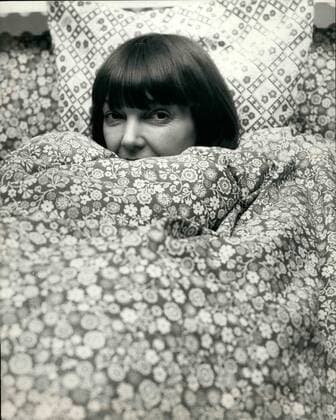 Feb. 02, 1974 - Russian Accuse Mary Quant.: In an article in the Soviet Culture Ministry newspaper, British fashion designer, Mary Quant, was attacked for being part of a sinister plot to divert British youth from revolutionary action. But the only revolution that British girls give credit to Miss Quant is her fashion revolution of the sixties, that brought in the Mini, Hot pants and the Mixture. Marry s latest revolution is new designs in bed wear. Photo shows Mary quant looks out from a sinister design - in quilt covers.  - ZUMAk09