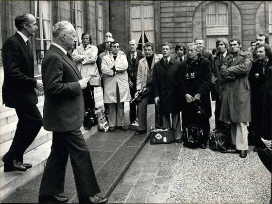 Mar. 20, 1974 - In an effort to protest against a law that prevents them from having permanent surveillance at the entrances and exits of the Elysee Palace, these press photographers refused to take pictures of the Ministers leaving their Council meeting yesterday afternoon. With their arms crossed and their cameras on the ground, press photographers watch Pierre Messmer and Giscard D Estaing Exit the Elysee Palace.  - ZUMAk09