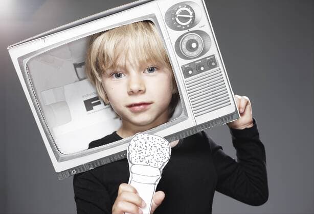 Portrait of boy head in paper TV with paper microphone against grey background model released  ED000015