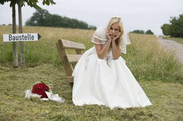 Bride sitting with head in hand, looking away. model released  MDF00317