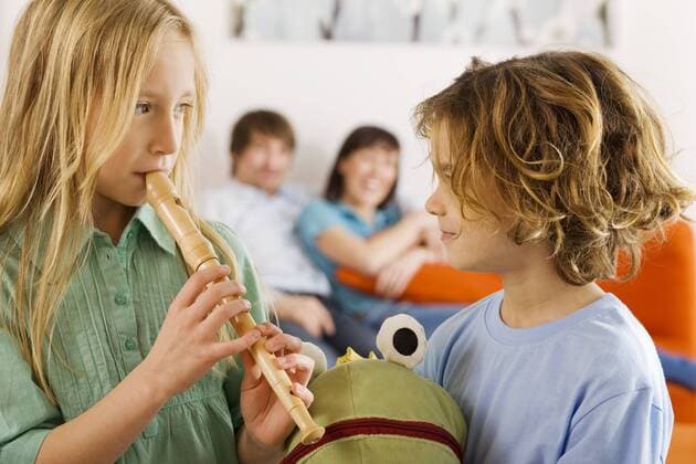 Boy (6-7) and girl (8-9), playing recorder model released property released  WESTF07264