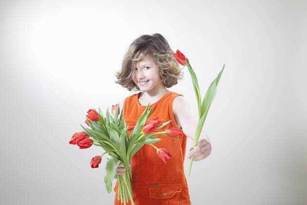 Girl with flowers for mother s day, smiling, portrait model released  MAEF003075