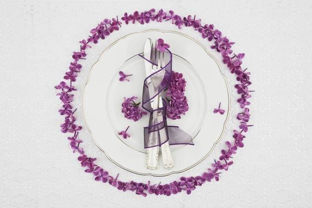 Place setting with lilac flower on tablecloth  GWF001976