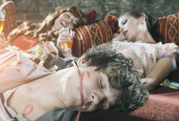 Germany, Berlin, Close up of young man and women relaxing on couch after party model released property released  WESTF016967