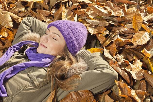 Germany, Berlin, Wandlitz, Mid adult woman lying in foliage model released  WESTF018305