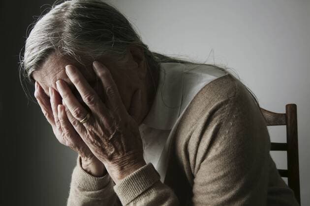 Senior woman covering face with her hands model released  JATF000651