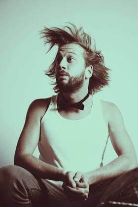 Portrait of astonished young man with blowing hair model released Symbolfoto  VEF000002