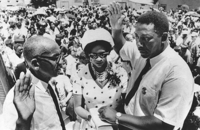 Fayette, Mississippi: July 7, 1969 Civil rights leader Charles Evers is sworn in as mayor of Fayette, Mississippi by Justice of Peace Willie Thompson. Mrs. Evers holds the Bible for her husband. Charles is the brother of slain rights activist Medgar Evers. 990_16_X-Evers-Charles_1HR