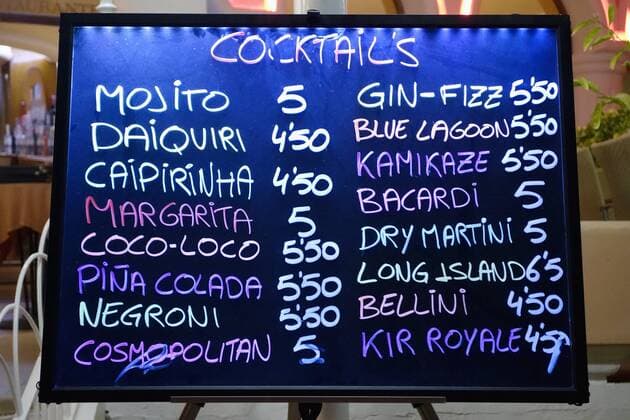 Spain, Ibiza, Santa Eulalia, board with cocktails at a bar  NDF000477