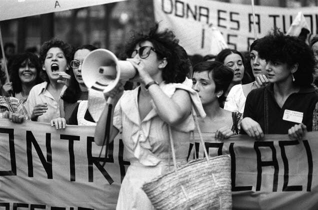 Woman with a loudspeaker tops the women s demonstration against violations. 