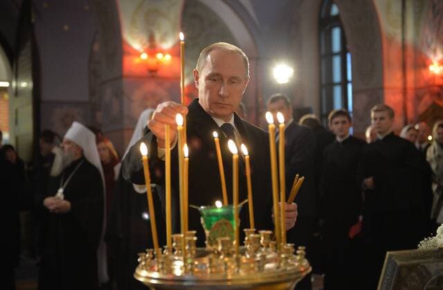 ST PETERSBURG, RUSSIA. DECEMBER 8, 2014. Russia s president Vladimir Putin (C) lights a candle as he visits the renovated Church of St Sergius of Radonezh at the Tsarskoye Selo State Museum-Preserve. Alexei Druzhinin Russian presidential press service TASS  RE15708C