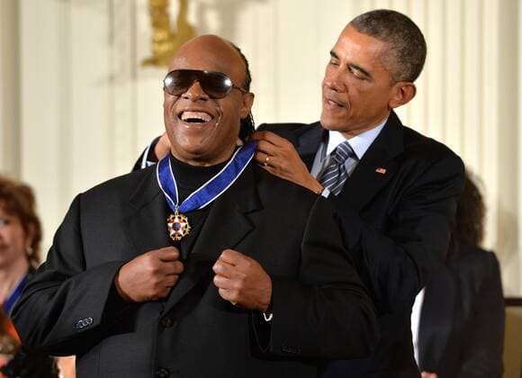 President Barack Obama awards musician Stevie Wonder the Presidential Medal of Freedom during a ceremony at the White House in Washington, D.C. on November 24, 2014.  POY20141231551