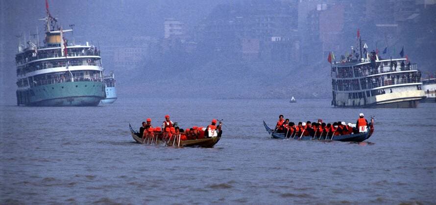 Am Yangtze-Fluss China Yangtze-Fluss in der Provinz Hubei China Die chinesische Regierung plant in der Provinz Hubei den Yangtze-Fluss mit einem Staudamm zur Stromgewinnung aufzustauen. Dabei werden ca. 3 Millionen Menschen umgesiedelt. Hier: Traditionelle Drachenboote auf dem Yangtze-Fluss im Drei Schluchten-Nationalpark . 1992, Zigui, Provinz Hubei China